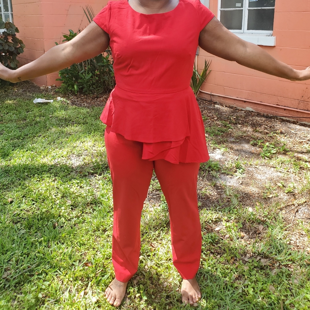 A red jumpsuit  With apeplum at the waist